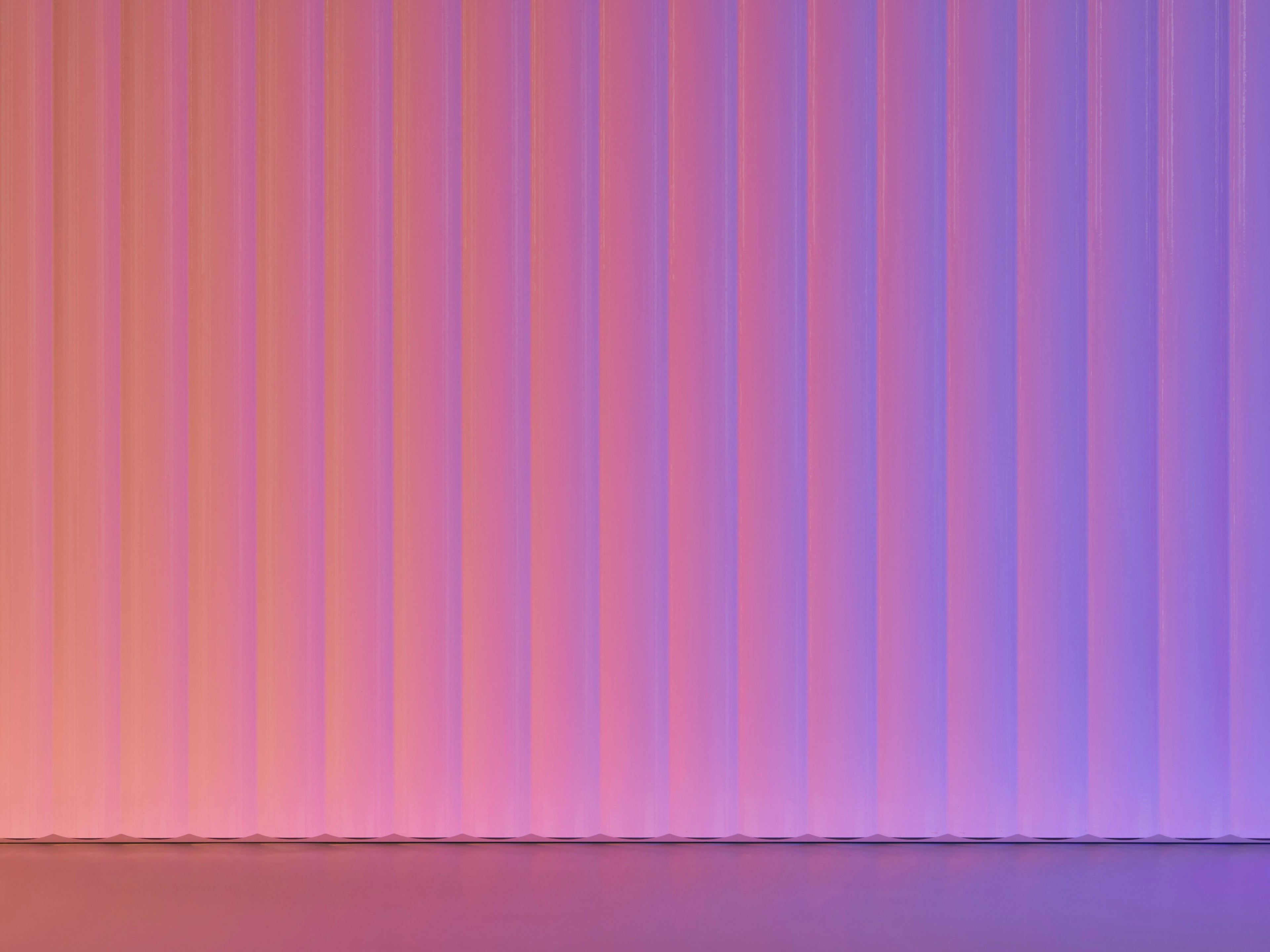 Striped fabric with pink and purple vertical stripes on a gradient background