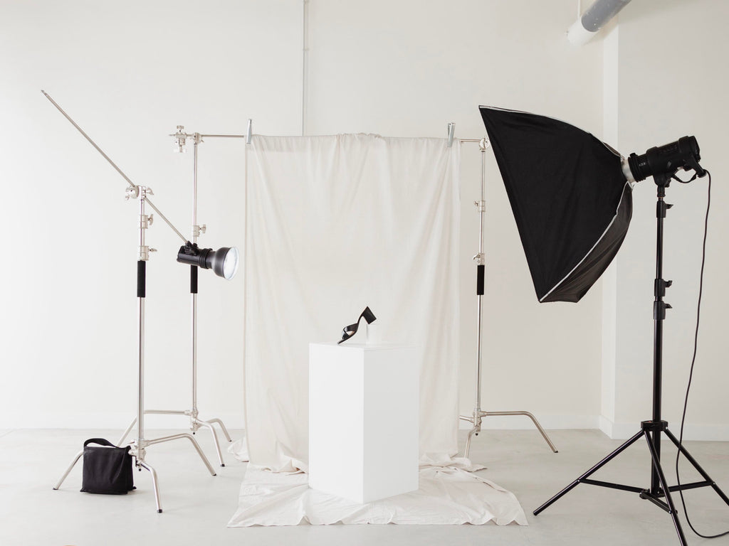Photography studio setup with lighting equipment and white backdrop