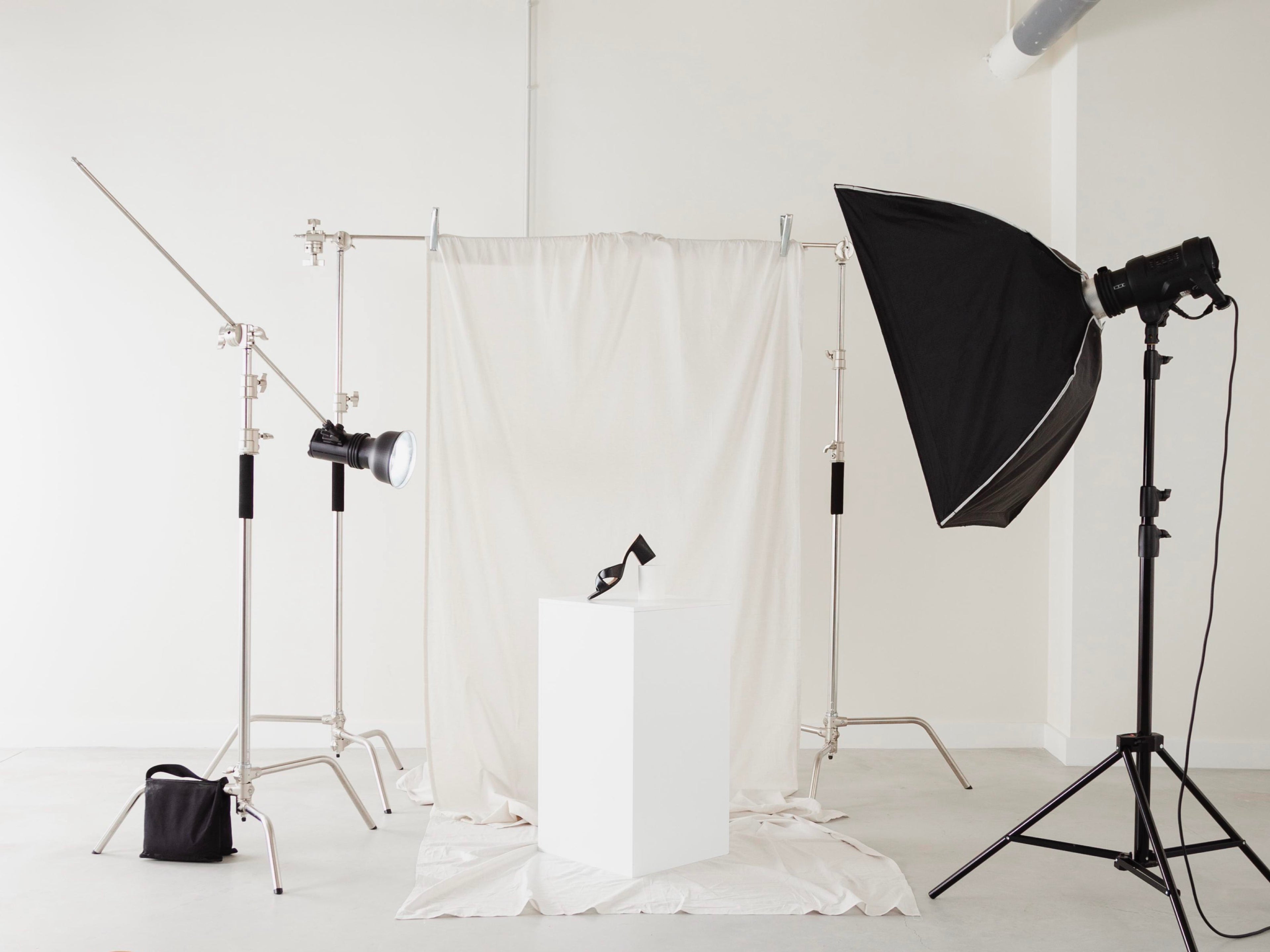 Photography studio setup with lighting equipment and white backdrop
